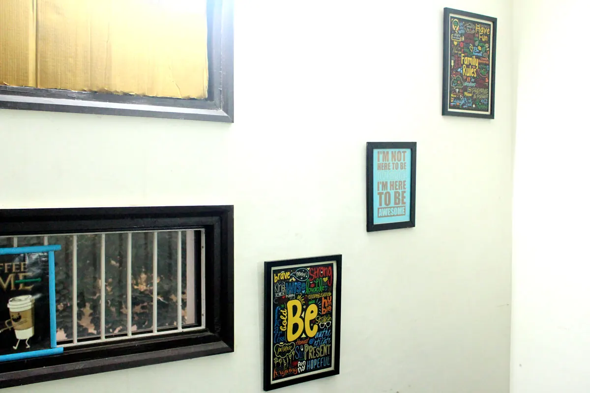 Framed prints hanging on a white wall