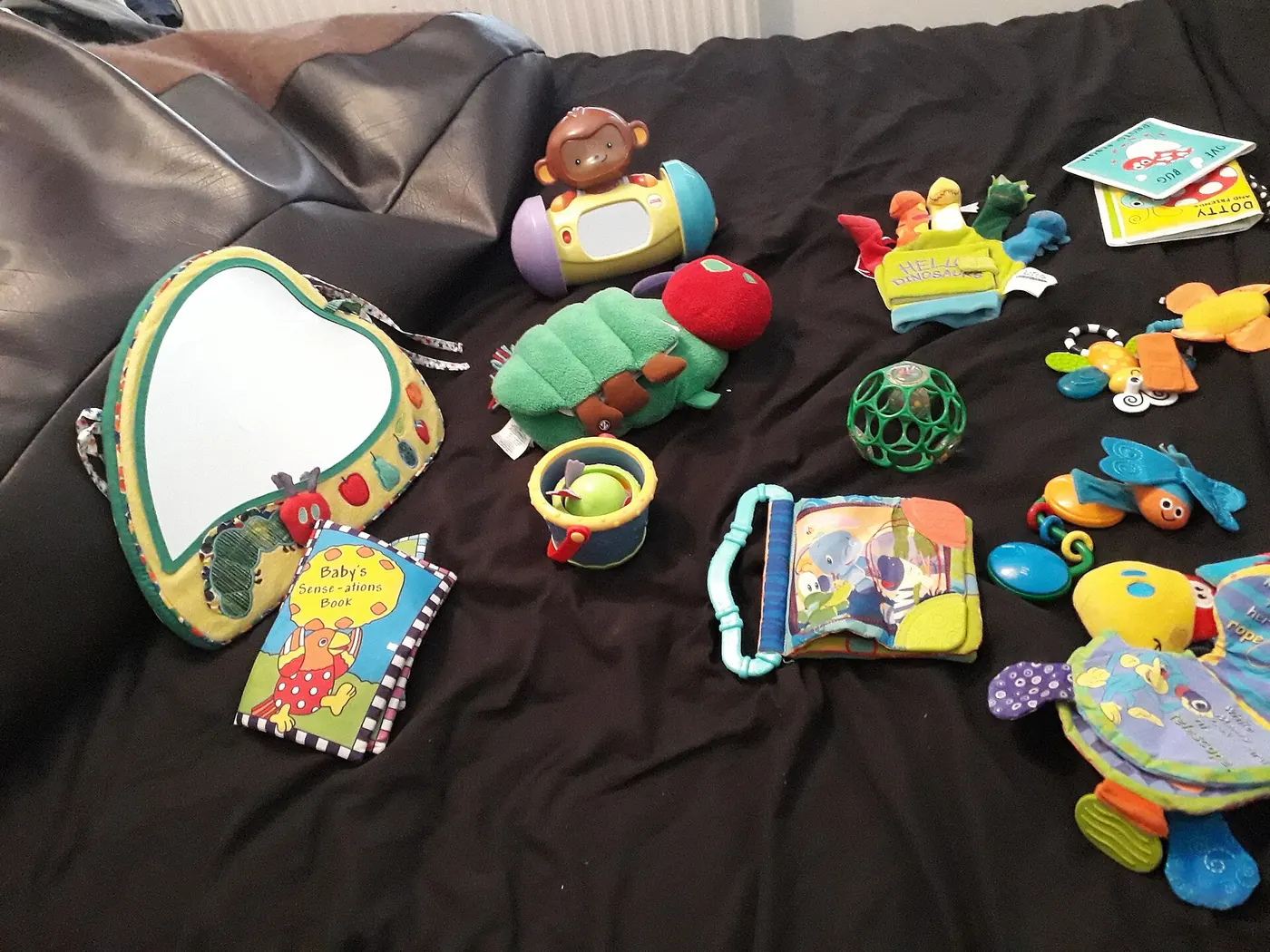 Colourful baby toys laid out on a blanket