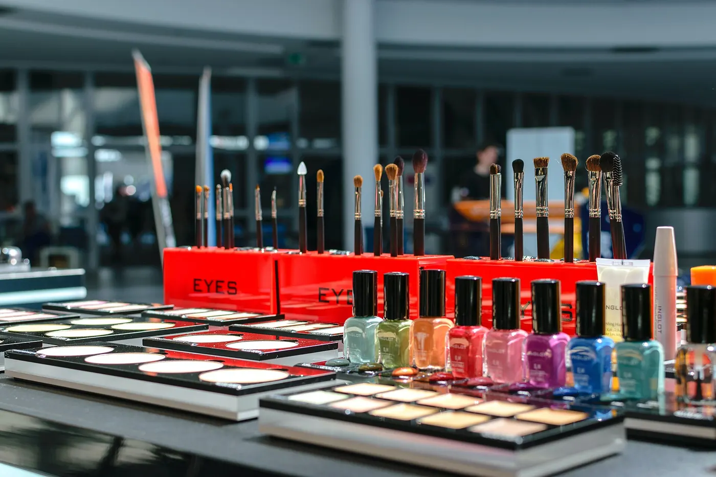 Rows of nail polish and cosmetics on a store display