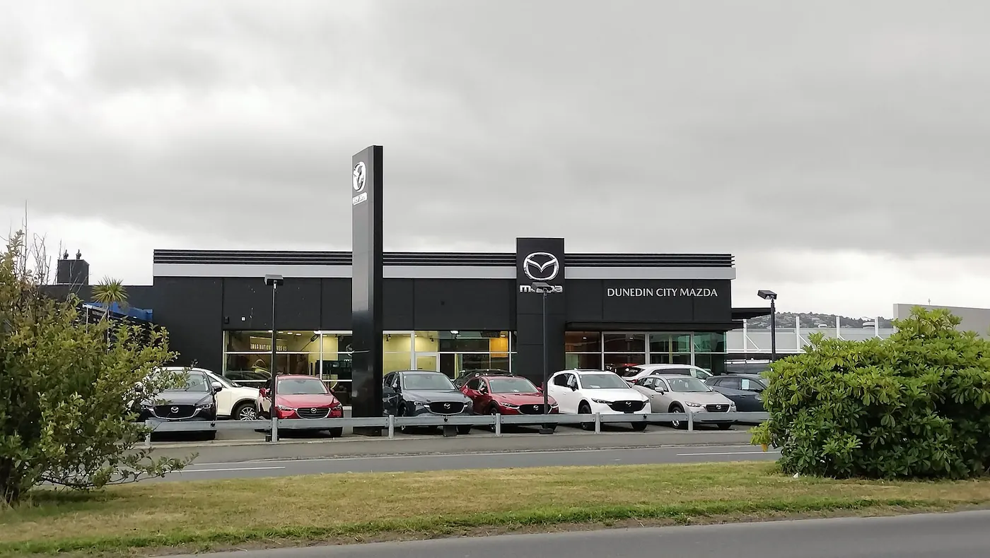 A car dealership with cars lined up outside
