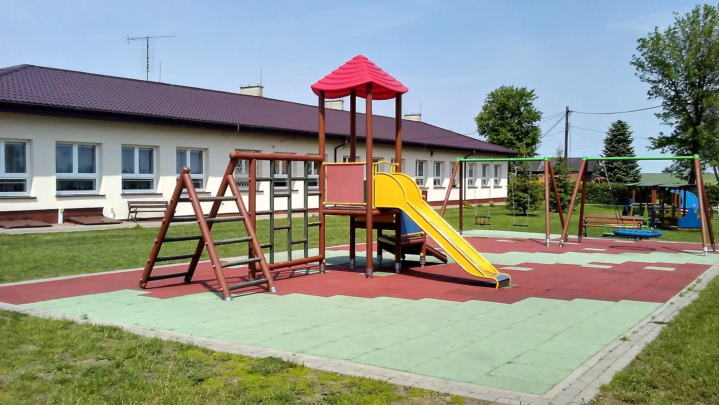 A nursery playground with a slide and climbing frame