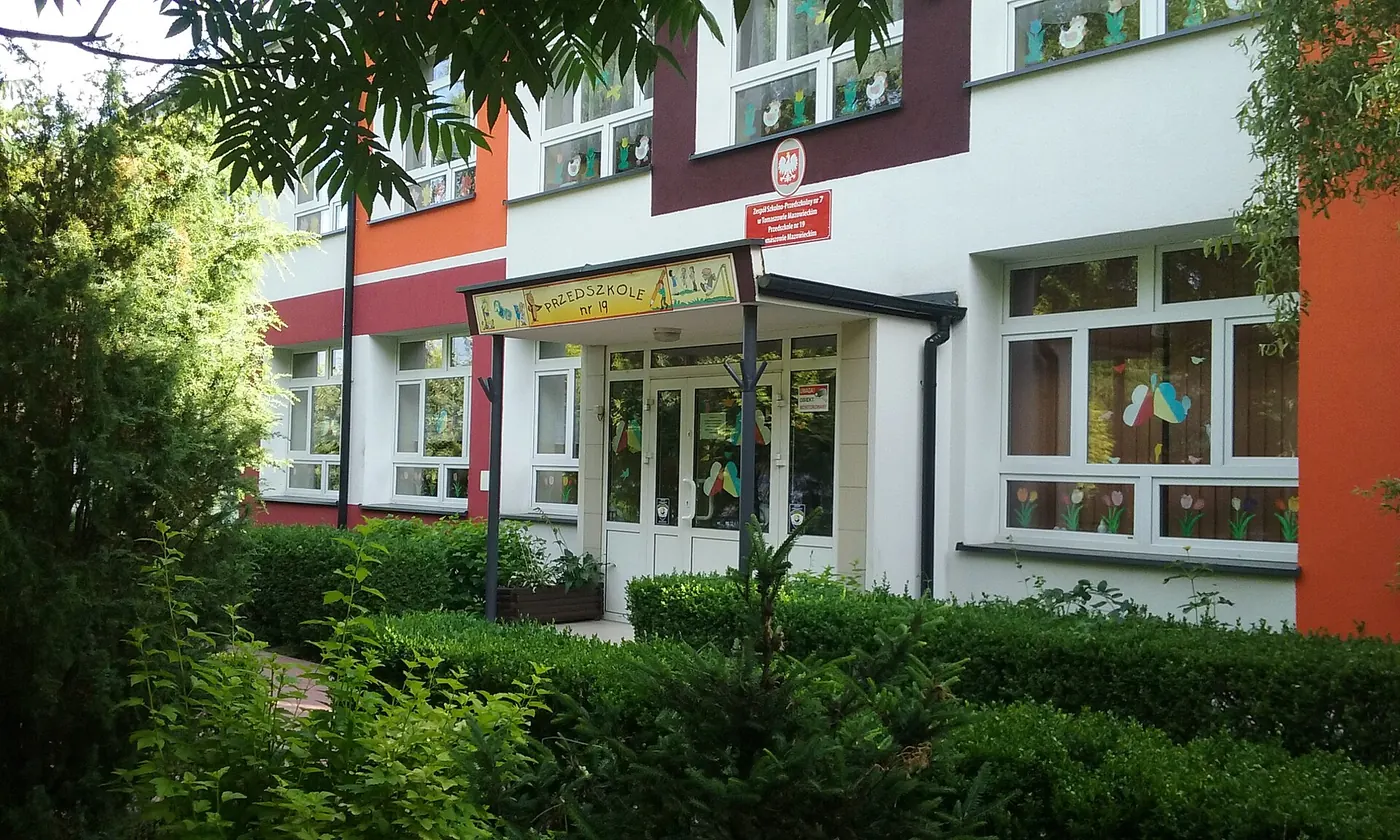 A nursery building surrounded by greenery