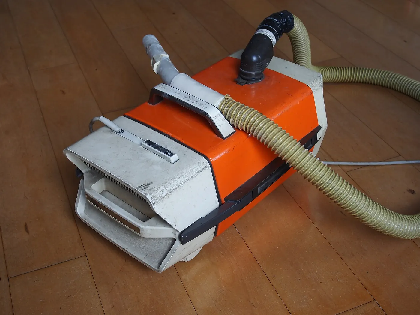 A vacuum cleaner on a wooden floor