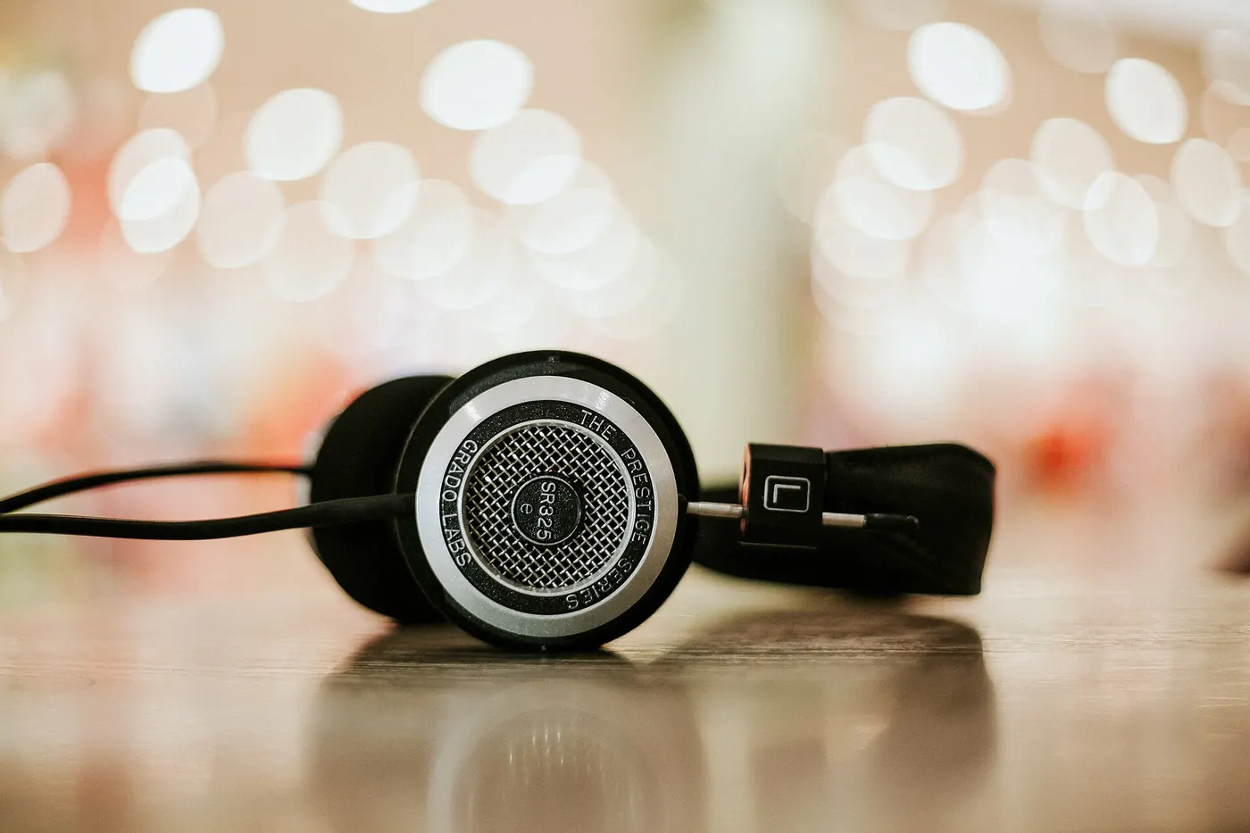 Headphones on a table with soft background lights