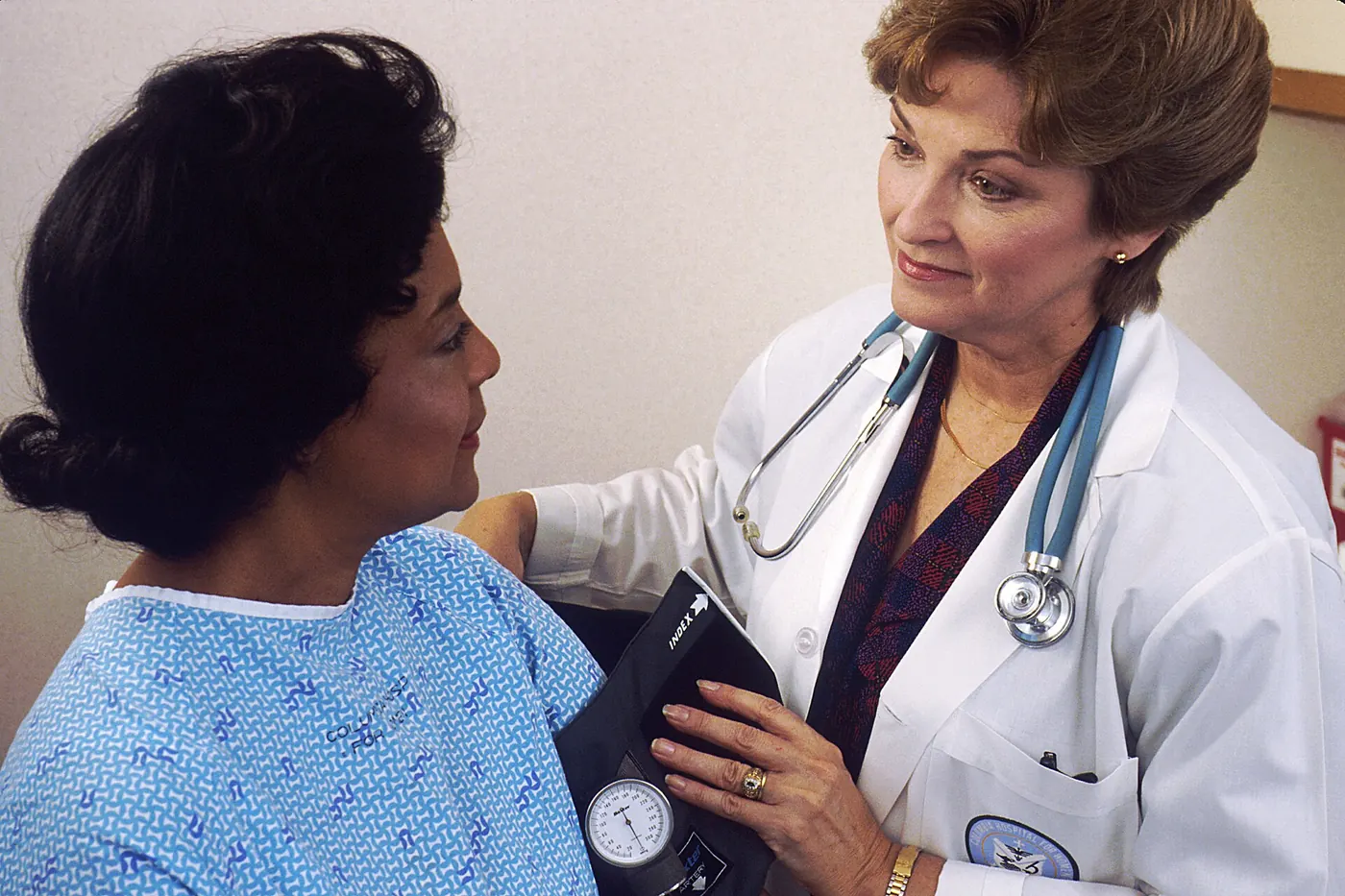 A doctor taking a patient's blood pressure