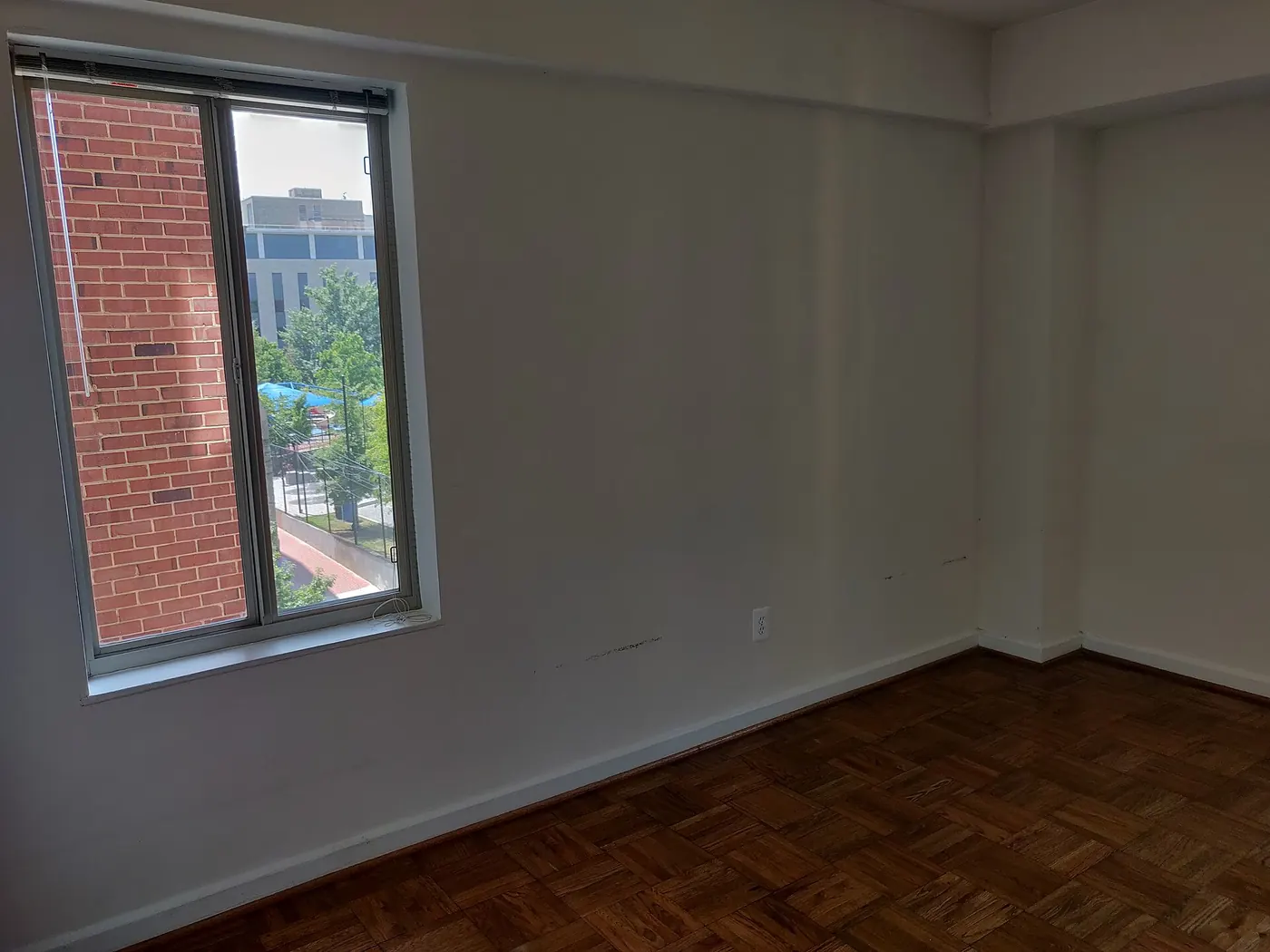An empty room with a polished wood floor