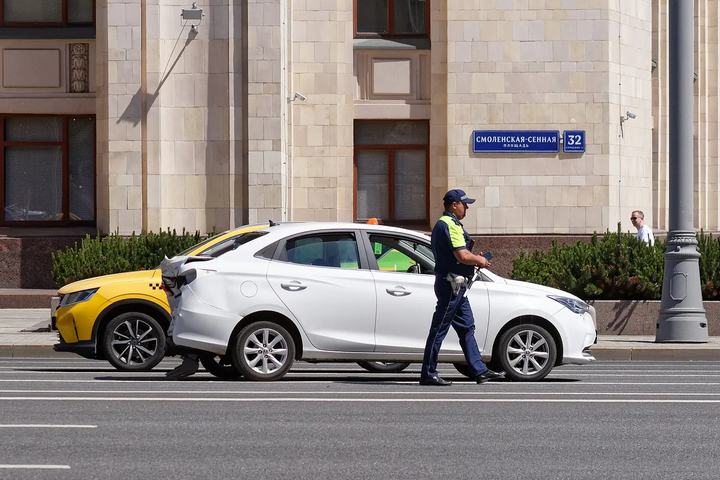 A traffic officer at the scene of a car collision