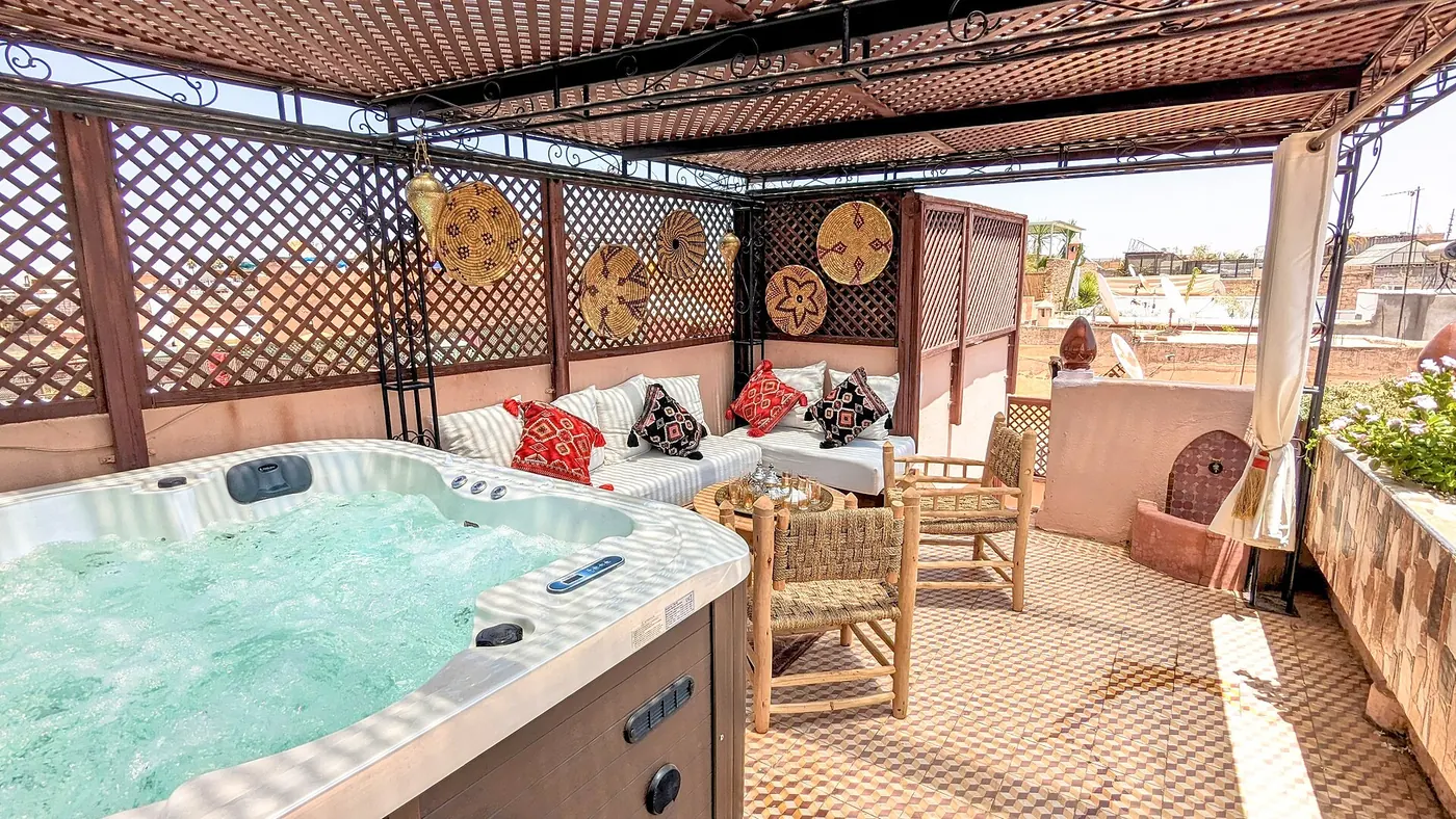 A rooftop terrace with a hot tub