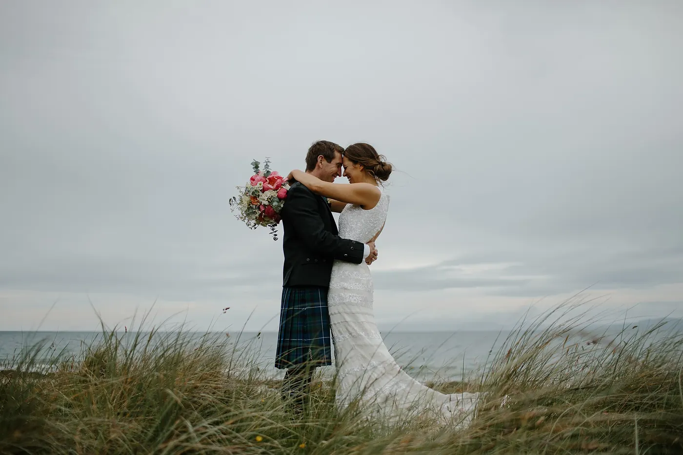 A bride and groom embracing outdoors
